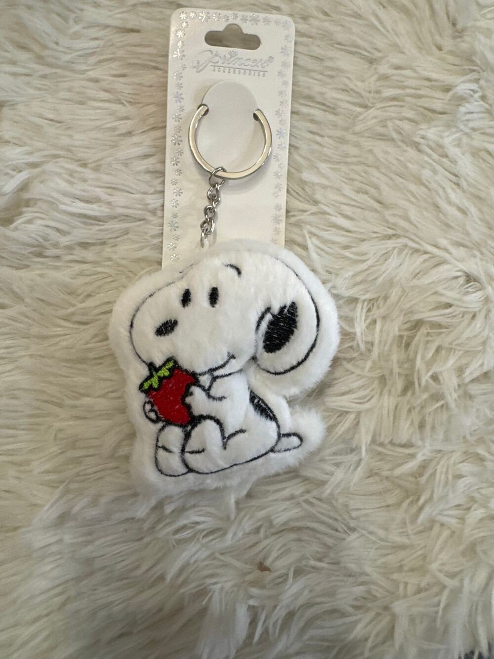 Snoopy Peanuts plush keychain bag charm holding a strawberry